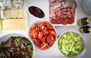 a table topped with bowls of different types of food at Island Boutique Hotel in Larnaca