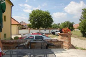 a patio with a car parked in a yard at Hotel Aurelius Mikulov in Mikulov