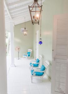 a hallway with blue chairs and a chandelier at Bungalow Sud in Habaraduwa Central