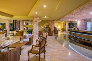 a lobby of a hotel with couches and chairs at Calheta Beach - All-inclusive - Savoy Signature in Calheta