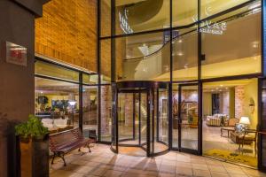 a store front with glass doors and a bench at Calheta Beach - All-inclusive - Savoy Signature in Calheta