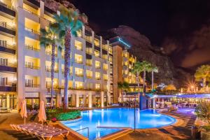 a hotel with a swimming pool at night at Calheta Beach - All-inclusive - Savoy Signature in Calheta