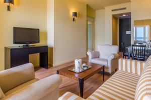 a living room with two couches and a tv at Calheta Beach - All-inclusive - Savoy Signature in Calheta