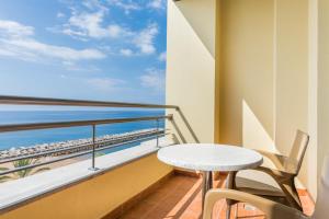 a balcony with a table and a view of the ocean at Calheta Beach - All-inclusive - Savoy Signature in Calheta