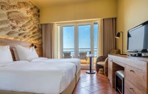 a hotel room with a bed and a television at Calheta Beach - All-inclusive - Savoy Signature in Calheta