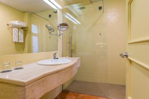 a bathroom with a sink and a shower at Calheta Beach - All-inclusive - Savoy Signature in Calheta