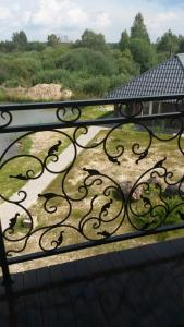 a view of a iron railing on a balcony at Dom v Belovezhskoi Pushcie in Kamenyuky