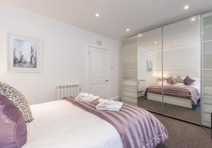 - une chambre avec un lit et un miroir dans l'établissement Castle Suite 1 Old Town, à Édimbourg