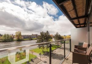 a balcony with a view of the river at The Metropole Residence in Glasgow
