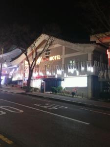 a building on a street at night with lights at Gyeongju bulgooksa W Drive-in Motel in Gyeongju