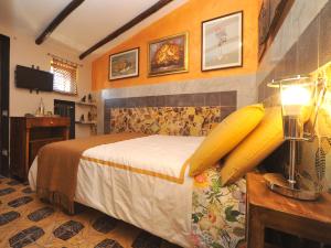 a bedroom with a bed and a table with a lamp at La Canonica dei Fiori - Anna Fendi Country House in Ronciglione