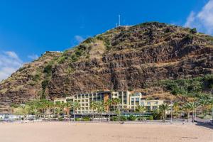 a view of a beach with palm trees and palm trees at Calheta Beach - All-inclusive - Savoy Signature in Calheta