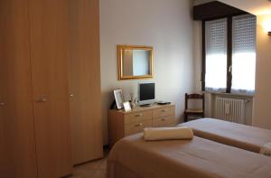 a bedroom with a bed and a desk at B. & B. NABUCCO in Parma