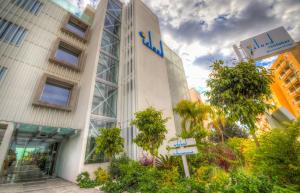 a building with a sign in front of it at Island Boutique Hotel in Larnaca