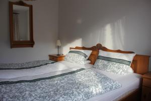 a bedroom with two beds and a mirror on the wall at Fewo Königsberger in Garmisch-Partenkirchen