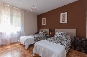 a bedroom with two beds and a window at 32 Marques Real in Madrid