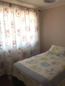 Ένα ή περισσότερα κρεβάτια σε δωμάτιο στο Casa Familiar La Serena