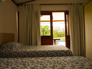 En eller flere senger på et rom på #VEMPRAPIPA - Casa no Madeiro em Condomínio - Piscina & WIFI