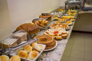 a buffet line with various pastries and other foods at Hotel Eliana in Matozinhos