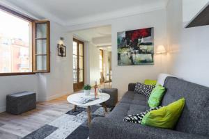 a living room with a couch and a table at LE ROSSETTI B. - modern, long balcony, old town Nice in Nice