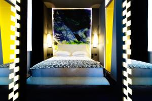 a bedroom with a bed with blue and yellow at Malmaison Hotel Leeds in Leeds