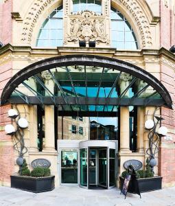 a building with a clock on the front of it at Malmaison Hotel Leeds in Leeds
