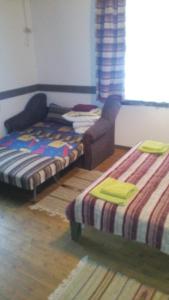 タターリウにあるMaghura Gostinnii Dvirのベッド2台と椅子が備わる客室です。