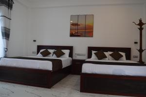Ένα ή περισσότερα κρεβάτια σε δωμάτιο στο Blue Wings Beach Hotel