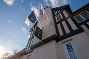 a building with two flags on top of it at Abbey Hotel in Leicester