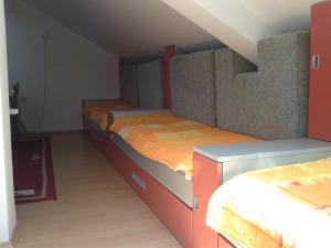 two beds in a room with an attic at Studio Pinos in Soko Banja