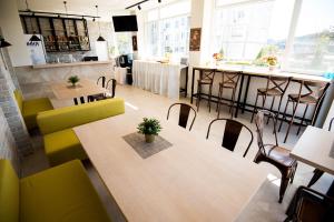 a restaurant with tables and chairs and a bar at Court Inn in Panagyurishte