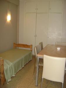 a room with a table and chairs and a bed at Departamento Pedro Luro in Mar del Plata