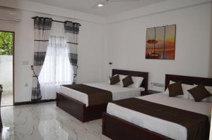 Ένα ή περισσότερα κρεβάτια σε δωμάτιο στο Blue Wings Beach Hotel