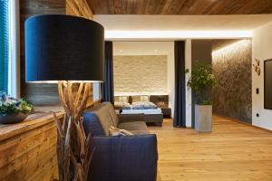 a living room with a couch and a lamp at Residence Rösch in Merano