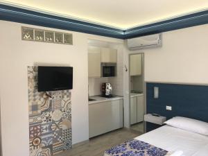 A kitchen or kitchenette at Elisir Suite Rooms by Marino Tourist
