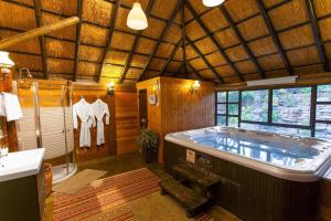 a large bathroom with a large tub in a house at Out of Africa Resort in Had Nes