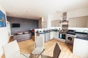 an open kitchen and living room with a couch at The Stay Company, Friar Gate in Derby