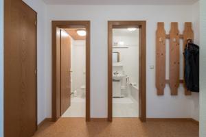 a bathroom with two sliding doors and a toilet at Haus Montana in Elbigenalp +26 photos