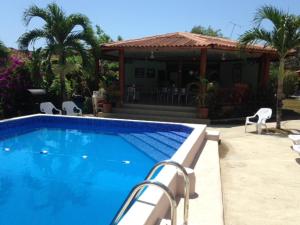 a swimming pool in front of a house at Casa Loma in Pedasí Town