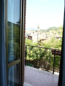 an open door to a balcony with a view at Hotel Pineta in Cagli