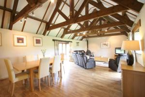 A television and/or entertainment centre at Polean Farm Cottages - With Free Animal Feeding and Pony Rides and Free Access to a Nearby Pool