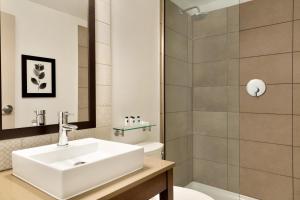 a bathroom with a sink, mirror, and bathtub at Country Inn & Suites by Radisson, Seattle-Tacoma International Airport, WA in SeaTac