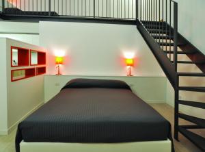 En eller flere senge i et værelse på BB Hotels Aparthotel Città Studi