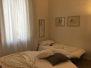 a bedroom with a white bed and white walls at B&B Cristina e Stefano in Pisa