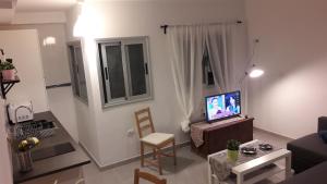 サンタ・クルス・デ・ラ・パルマにあるApartamento La Recovaのリビングルーム(テレビ、テーブル、椅子付)