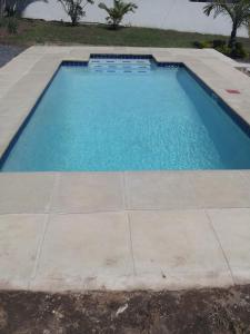 a large swimming pool with a tile floor at Malusi Bed and Breakfast in Verulam