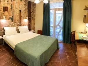 Voodi või voodid majutusasutuse Komilfo Hotel toas