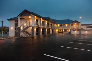 a large parking lot in front of a building at Harbour View Motel in Timaru
