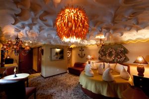 a bedroom with a large bed with a chandelier at The Roxbury in Roxbury