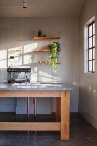 a kitchen with a wooden table with a counter top at Piermont Retreat in Swansea